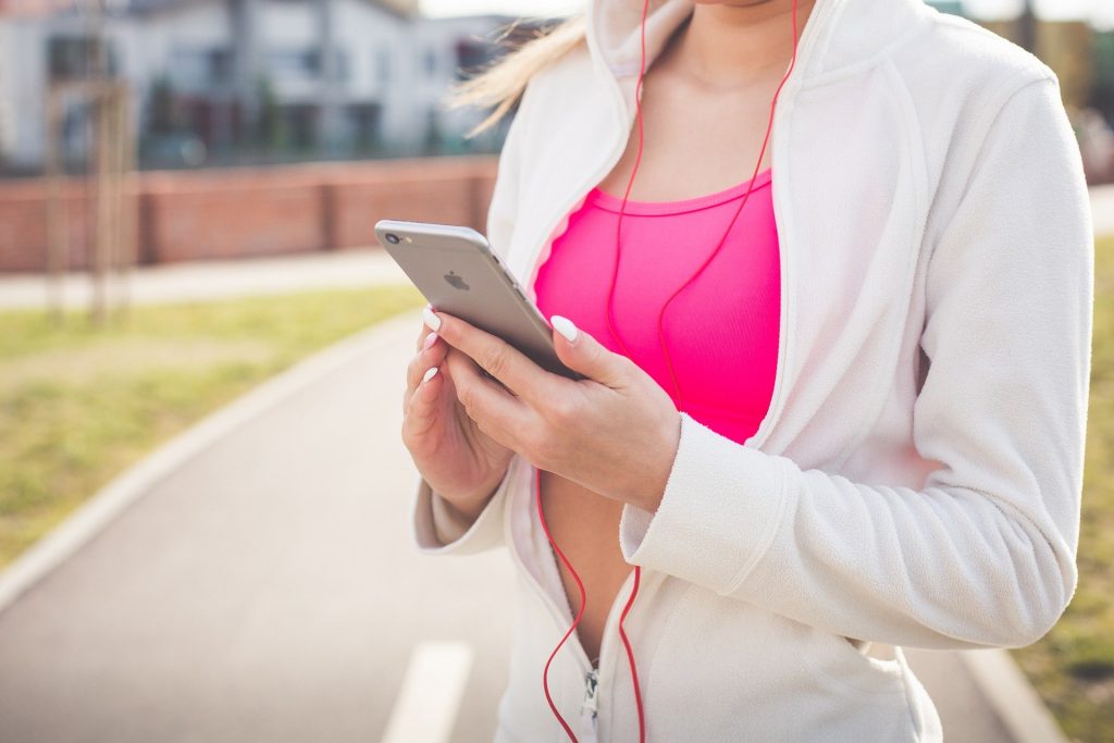 Reaching goals - Woman working out listening to headphones