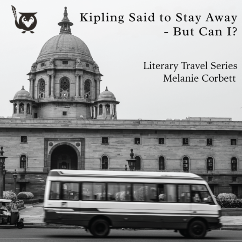 A black-and-white photograph shows a large domed government building with ornate stone architecture dominating the background. In the foreground, a city bus passes across the frame, slightly blurred to convey motion and everyday urban life. The contrast between the historic structure and modern traffic creates a sense of movement through time. Calcutta TEXT: Kipling Said to Stay Away – But Can I; Literary Travel Series; Melanie Corbett