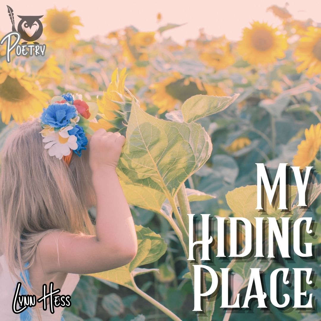My_Hiding_Place A young child with long blonde hair stands among tall sunflower plants, lifting a large green leaf to look beneath it. The child wears a colorful flower headband with blue, white, and yellow blossoms, surrounded by bright yellow sunflowers filling the background. sunflowers TEXT: My Hiding Place, Lynn Hess, Poetry
